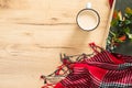 Book, knitted red scarf, cup of coffee on wooden table. Flat lay, top view, copy space. Hygge autumn concept