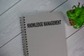 The book of Knowledge Management isolated on Wooden Table Royalty Free Stock Photo