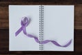 Book and lavender ribbon on a wooden table