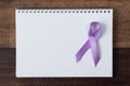 Book and lavender ribbon on a wooden table
