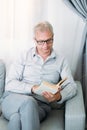 book leisure reading hobby home mature man couch Royalty Free Stock Photo