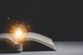 Book and light bulb style vintage dark background,.Concept The idea of reading books, knowledge, and searching for new ideas Royalty Free Stock Photo