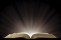 A Book that looks like a Bible Open in a Dark Room Royalty Free Stock Photo