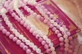 Book of magic spells with pink agate and crystal quartz mineral stone beads