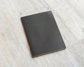 Book mockup blank black A4 leather cover for magazine, booklet, brochure, menu, diary mock-up design template on wooden table Royalty Free Stock Photo