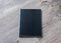 Book mockup blank black A4 leather cover for magazine, booklet, brochure, menu, diary mock-up design template on wooden table Royalty Free Stock Photo