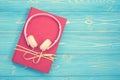 Book and new modern pink music headphone on blue wooden plank ba Royalty Free Stock Photo