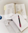 A book, pen, notebook and a water bottle