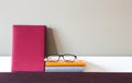 Book, Notebooks and glasses on shelf