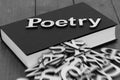 Book novel with the word poetry and blurred letters coming out of the pages Royalty Free Stock Photo