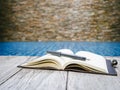 Book open page with pen on wooden background