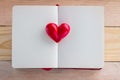 Book with opened pages and clay heart shape in the middle Royalty Free Stock Photo