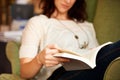 This book is a page turner. A cropped shot of a young woman reading a book while seated. Royalty Free Stock Photo