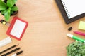 Book, paperclip, pencil, ruler, Highlighting pen, employee card, post it and tree pot on rustic brown wooden desk. Lifestyle works Royalty Free Stock Photo