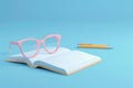 A book with a pen and a pair of glasses on top of it with Generative AI Royalty Free Stock Photo