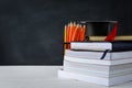 book and pencil on white table black board background Royalty Free Stock Photo