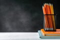 book and pencil on white table black board background with study Royalty Free Stock Photo