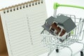 A Book Rankingslist and Shopping Cart and house model . using as background business concept and Planning concept with copy spac