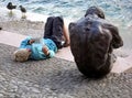 Book reading on a lake near a male sad bronze statue