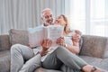 Book, reading and relax with a senior couple sitting on a sofa in the living room of a home together. Books, love and Royalty Free Stock Photo