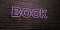 BOOK -Realistic Neon Sign on Brick Wall background - 3D rendered royalty free stock image Royalty Free Stock Photo