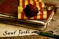 Book, rose, catalan flag and text Sant Jordi Royalty Free Stock Photo