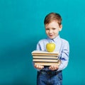 Book, school, kid. little student holding books. Cheerful smiling little kid against chalkboard. Royalty Free Stock Photo