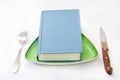 Book served on the plate with fork and knife