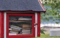 Book sharing mini house near the river. Royalty Free Stock Photo