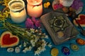 Book of spells, candles and chakras on witch ritual table. Occult, esoteric and divination still life. Mystic background with