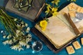 Book of spells, open diary and runes with flowers on ritual altar table. Occult, esoteric and divination still life. Mystic