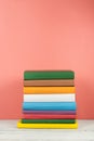 Book stack, hardback colorful books on wooden table and blue background. Back to school. Copy space for text. Education concept Royalty Free Stock Photo