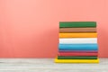 Book stack, hardback colorful books on wooden table and blue background. Back to school. Copy space for text. Education concept Royalty Free Stock Photo
