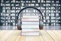 Book stack with headphones in library