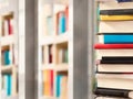 Book stack in the library room and blurred bookshelf background for business, education and back to school concept Royalty Free Stock Photo