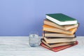 Book stacking. Open book, hardback books on wooden table and blue background. Back to school. Copy space for text Royalty Free Stock Photo