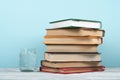 Book stacking. Open book, hardback books on wooden table and green background. Back to school. Copy space for text Royalty Free Stock Photo