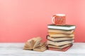 Book stacking. Open book, hardback books on wooden table and pink background. Back to school. Copy space for text Royalty Free Stock Photo