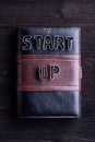 Book with start up sign laid on wooden background Royalty Free Stock Photo