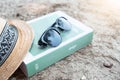 Book and sunglasses on beach for summer holiday. Royalty Free Stock Photo
