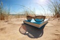 Book and sunglasses on the beach Royalty Free Stock Photo