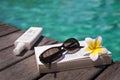 Book and sunglasses, blue water Royalty Free Stock Photo