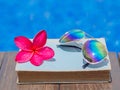 Book and sunglasses, blue water background, Royalty Free Stock Photo