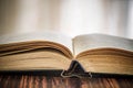 Book or textbook open old, black cover, close-up, selective focus Royalty Free Stock Photo