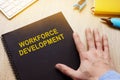Book with title workforce development on desk. Royalty Free Stock Photo