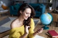 Book travel online. Portrait of a woman with a smartphone at home