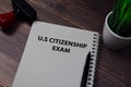 Book about U.S Citizenship Exam isolated on wooden table