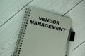 The book about Vendor Management isolated on wooden table