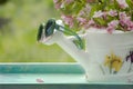 Book on the white vintage table with vase and sunglasses on green grass on sunny summer day, soft focus. Lawn with spring flowers Royalty Free Stock Photo