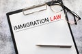 Book with words Immigration Law and glasses Royalty Free Stock Photo